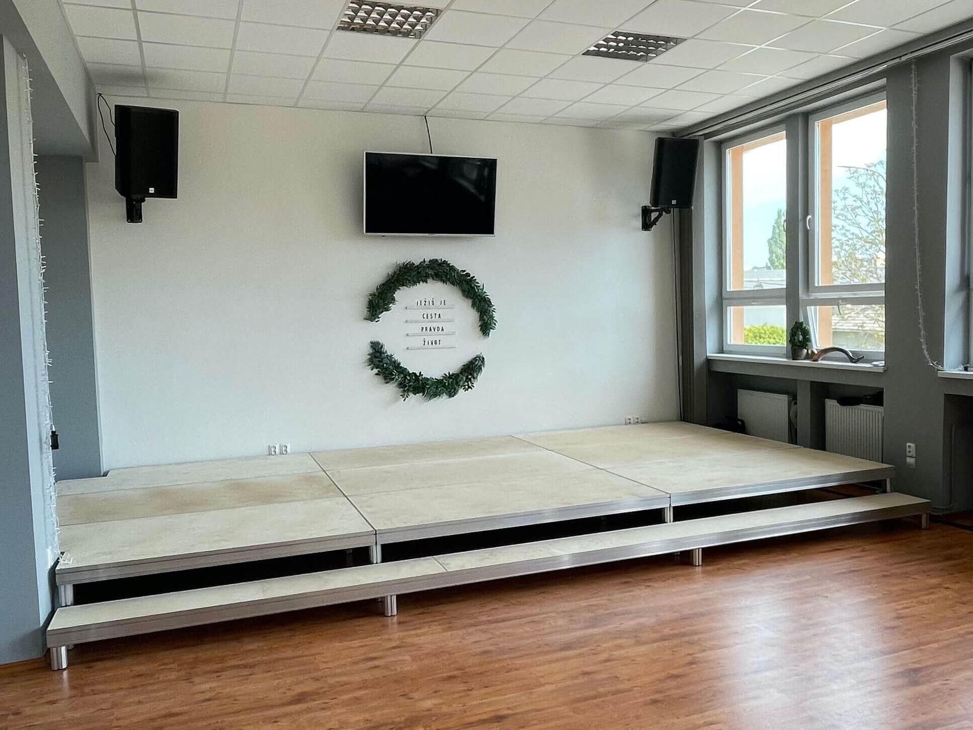 Nízke pódium v sále s drevenou podlahou